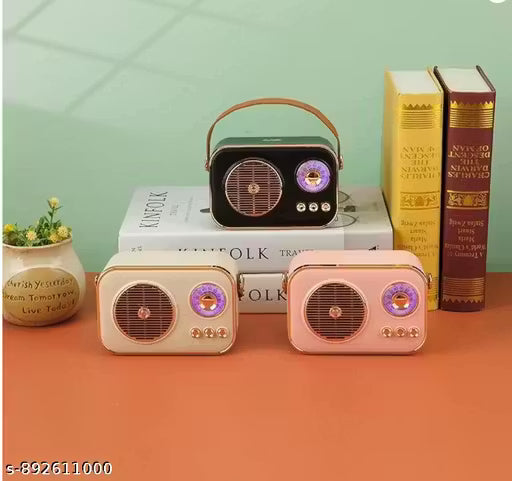 Three vintage-style radios on books with a green wall and orange surface